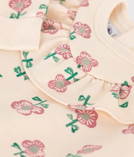 Un sweatshirt beige à motif imprimé de roses, avec un col popeline.