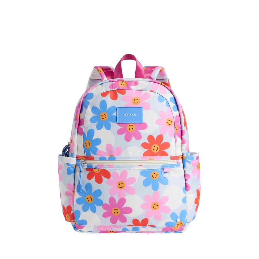 Un sac à dos bland à motif de marguerites colorées.