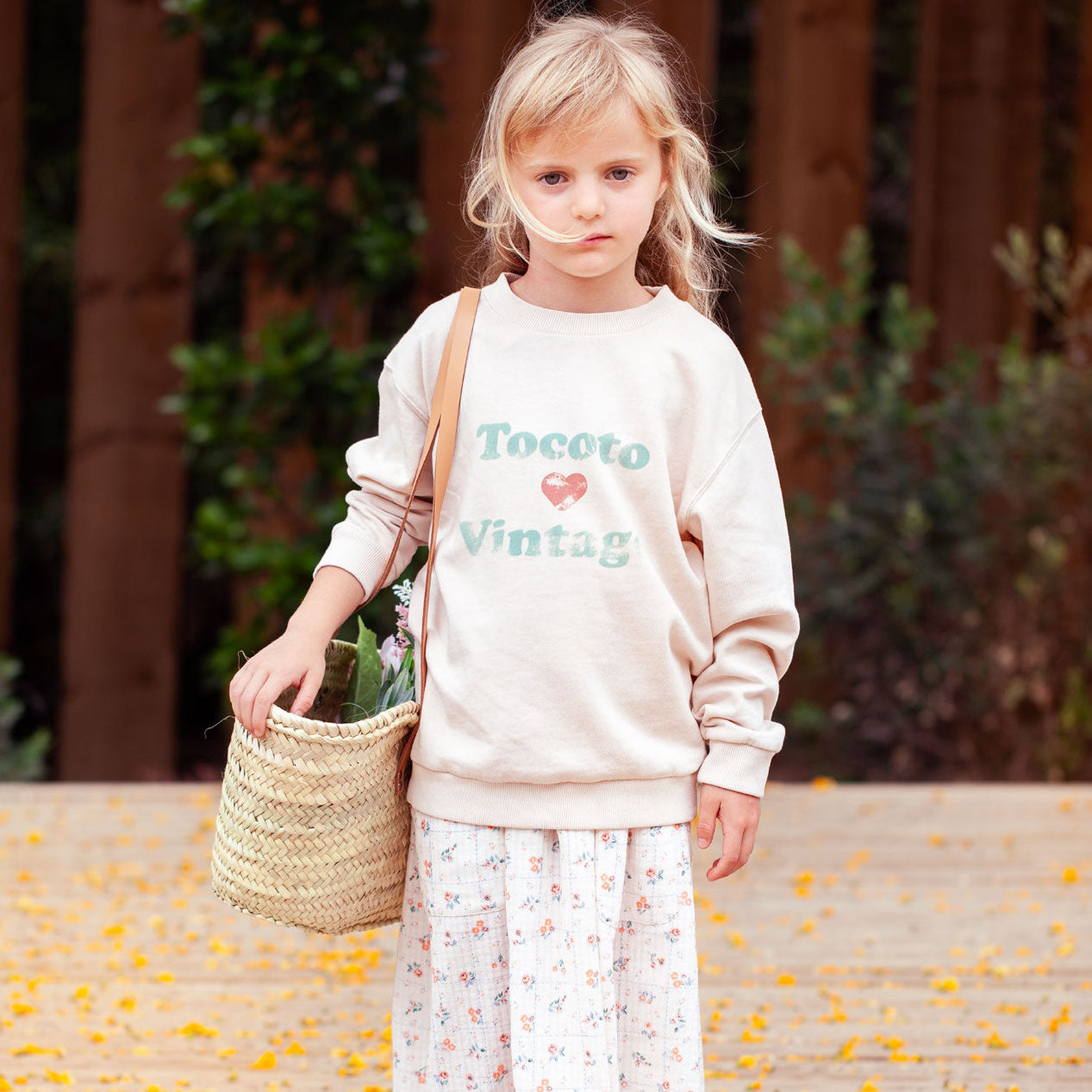 Fille avec un panier et une tenues Tocoto Vintage, une marque pour enfants disponible chez Billie Le Kid.